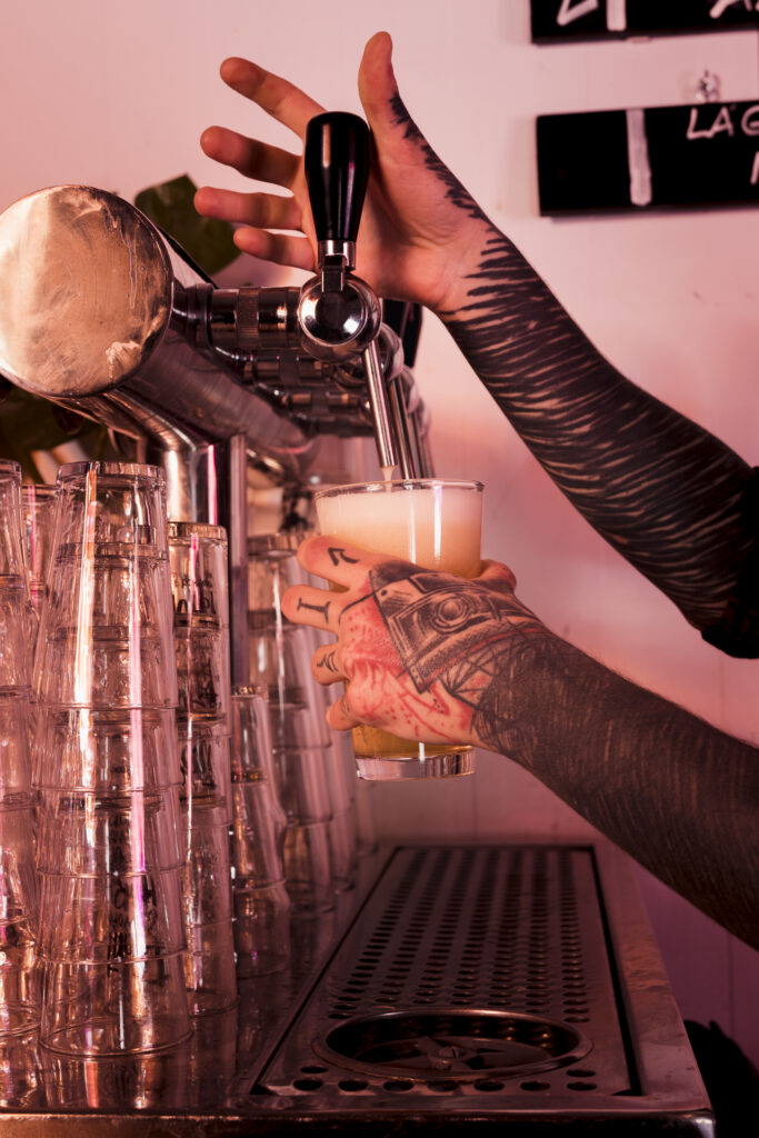 man with tattoos producing craft beer